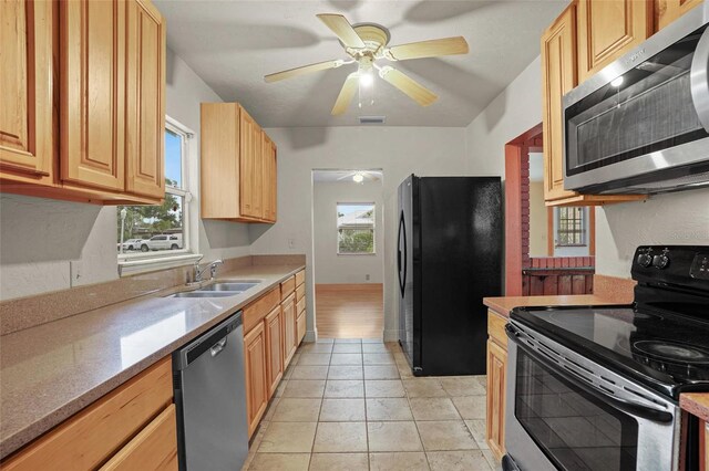 kitchen featuring light countertops, visible vents, appliances with stainless steel finishes, a ceiling fan, and a sink