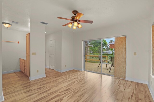 unfurnished room with baseboards, visible vents, and light wood-style floors