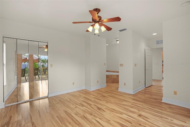 unfurnished room with a ceiling fan, baseboards, visible vents, and light wood finished floors