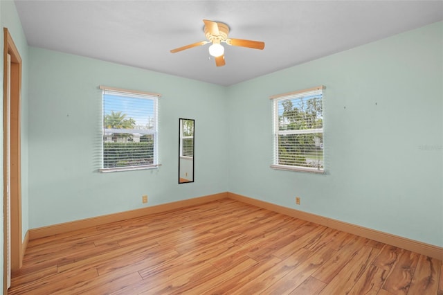 spare room featuring light wood-style floors, ceiling fan, and baseboards