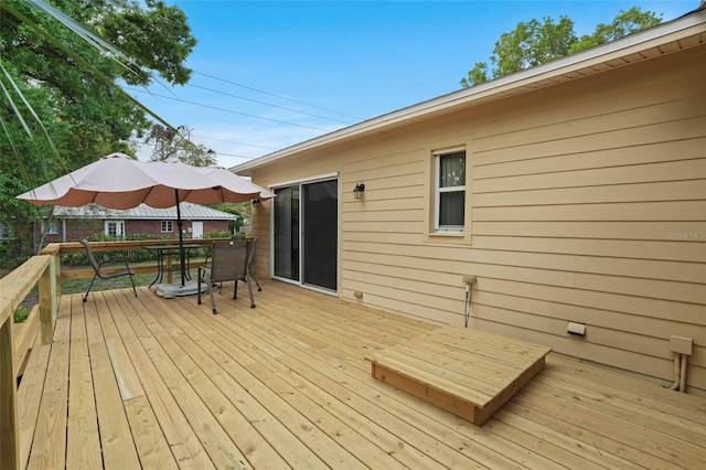 wooden terrace with outdoor dining space