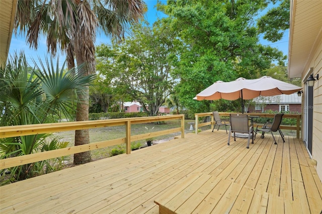 wooden terrace featuring outdoor dining space