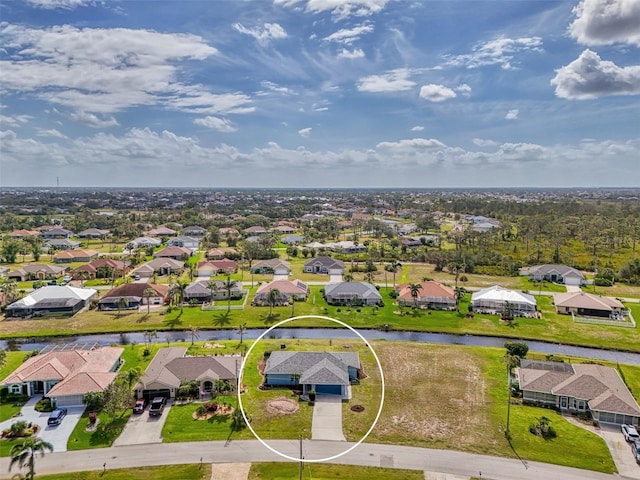 drone / aerial view with a residential view and a water view