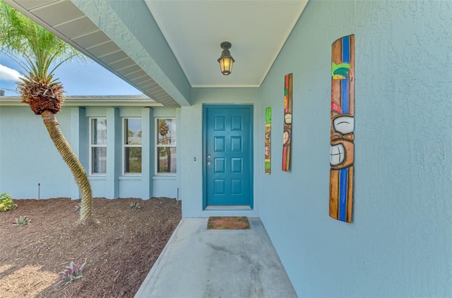 entrance to property with stucco siding