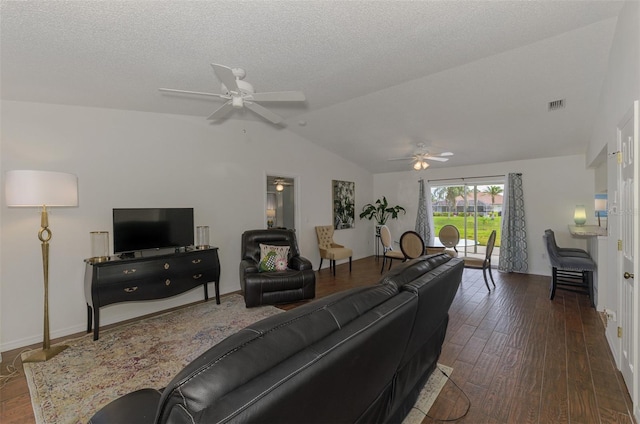 living room with a textured ceiling, vaulted ceiling, dark wood finished floors, and a ceiling fan