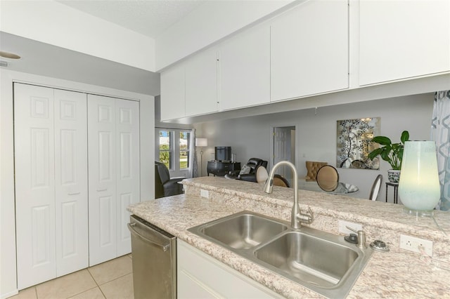 kitchen with dishwasher, light countertops, a sink, and white cabinets