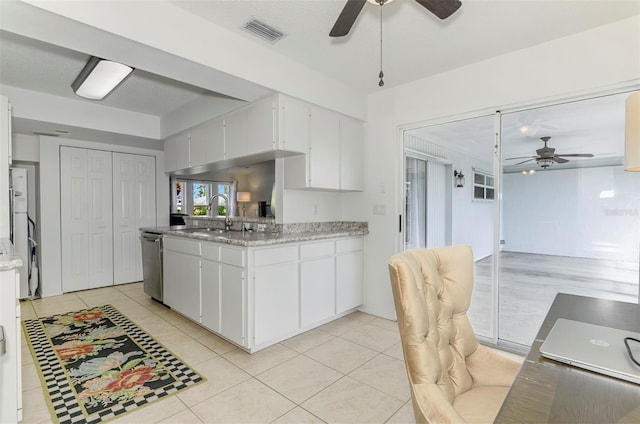 kitchen with white cabinetry, visible vents, a sink, and light tile patterned flooring