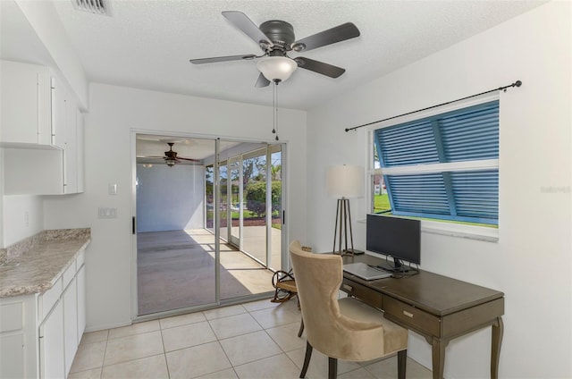 office area with visible vents, ceiling fan, a textured ceiling, and light tile patterned flooring