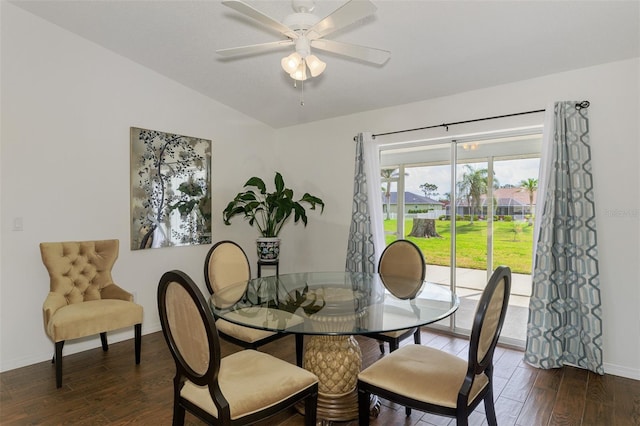 dining room with a ceiling fan, baseboards, vaulted ceiling, and wood finished floors