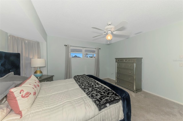 bedroom featuring a textured ceiling, ceiling fan, carpet floors, visible vents, and baseboards