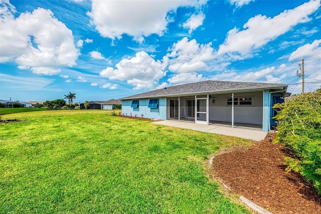 back of property with a yard and a patio