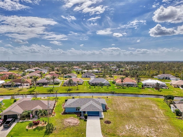 drone / aerial view featuring a residential view and a water view