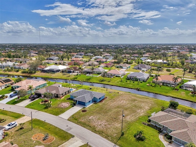 drone / aerial view with a residential view and a water view