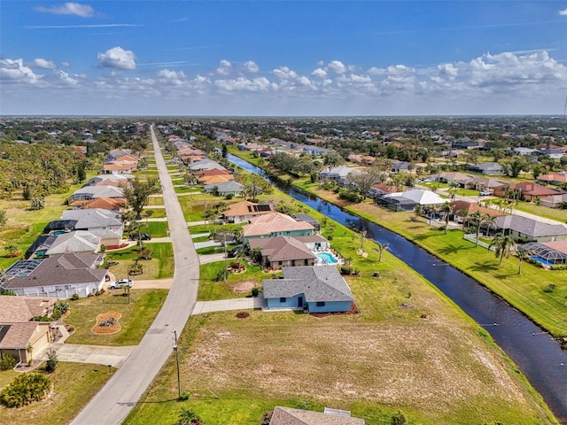 drone / aerial view with a water view and a residential view