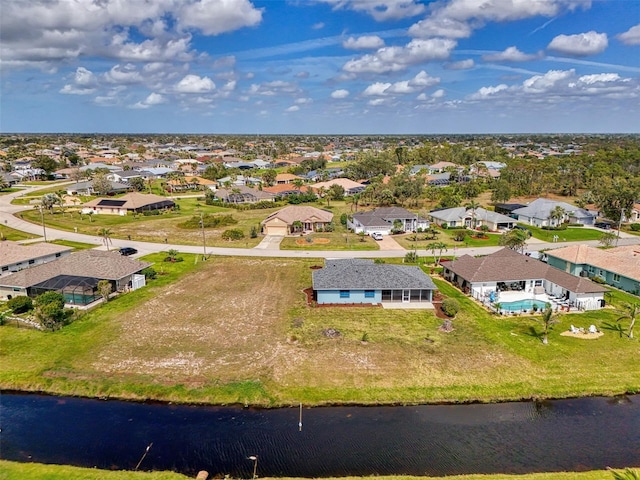 drone / aerial view featuring a water view and a residential view