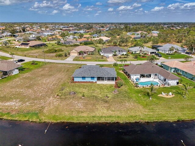 drone / aerial view with a residential view and a water view