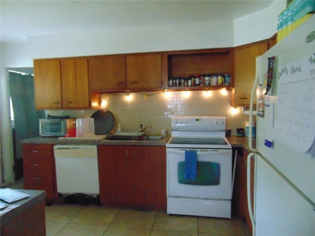 kitchen with brown cabinets, white appliances, a sink, and tasteful backsplash