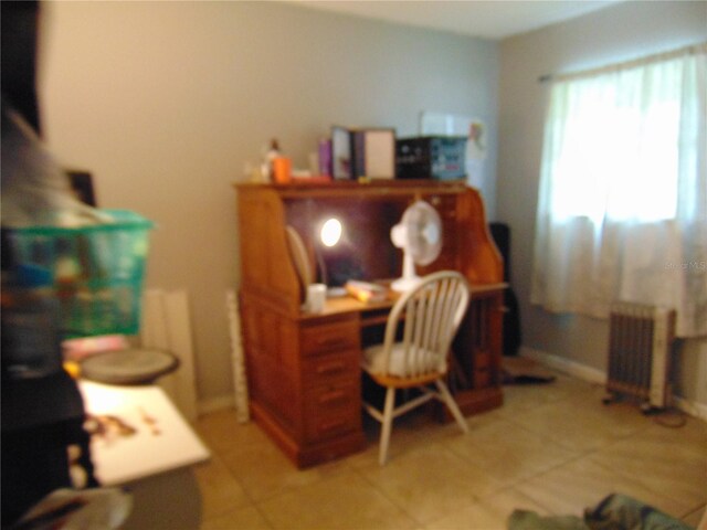 office area featuring light tile patterned floors, radiator heating unit, and baseboards