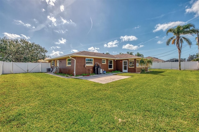 back of property featuring a patio area, a fenced backyard, and a yard