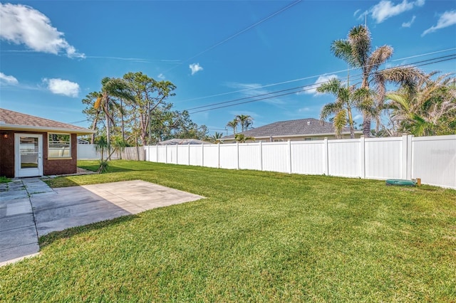 view of yard with a patio area and a fenced backyard