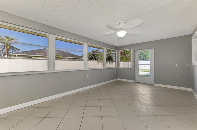 unfurnished sunroom with ceiling fan