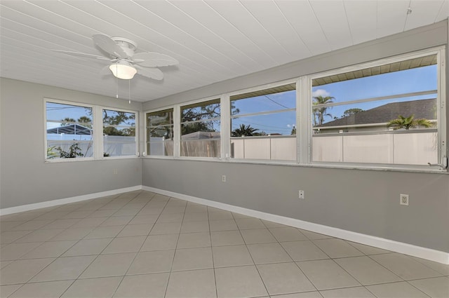 unfurnished sunroom featuring a wealth of natural light and ceiling fan