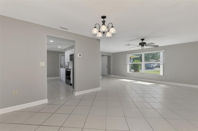 spare room featuring light tile patterned flooring, visible vents, baseboards, and ceiling fan with notable chandelier