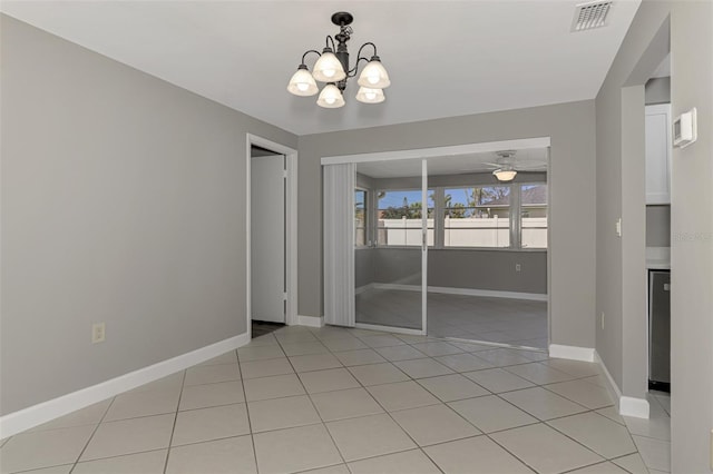 unfurnished dining area featuring ceiling fan with notable chandelier, visible vents, baseboards, and light tile patterned flooring