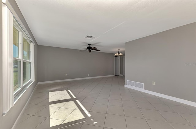 spare room with visible vents, baseboards, and light tile patterned floors