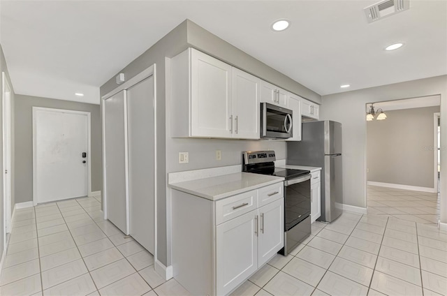 kitchen with stainless steel appliances, light countertops, visible vents, and light tile patterned floors