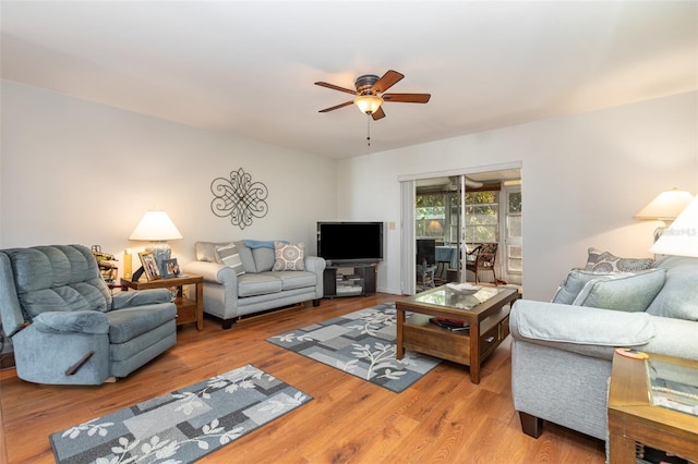 living room with ceiling fan and wood finished floors