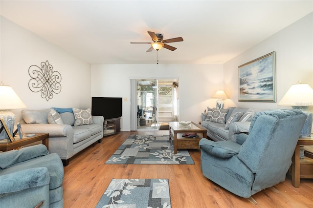 living room featuring a ceiling fan and wood finished floors