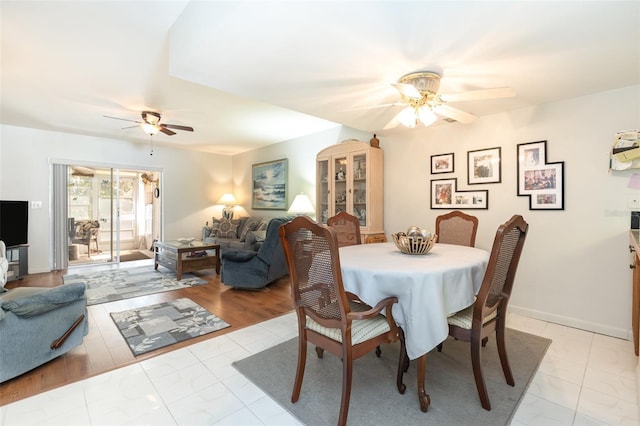 dining space with baseboards and a ceiling fan