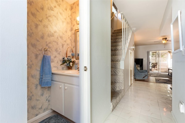 bathroom featuring baseboards, wallpapered walls, vanity, and a ceiling fan