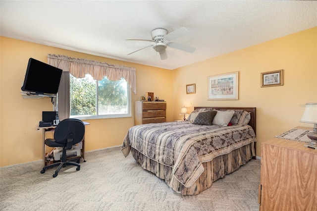 bedroom with a textured ceiling, carpet, and a ceiling fan