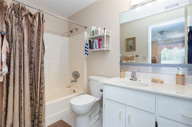 bathroom with tile patterned floors, shower / bath combo with shower curtain, toilet, a textured ceiling, and vanity