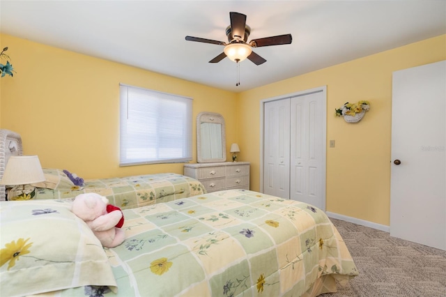 bedroom featuring a closet, baseboards, a ceiling fan, and carpet flooring