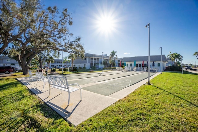 view of home's community featuring shuffleboard and a lawn