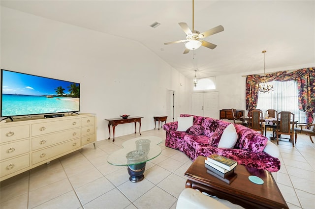 living area with lofted ceiling, visible vents, light tile patterned flooring, and ceiling fan with notable chandelier