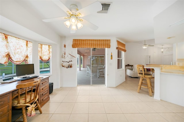 office featuring light tile patterned floors, visible vents, and a ceiling fan