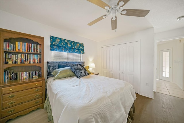 bedroom featuring a closet, ceiling fan, and wood finished floors