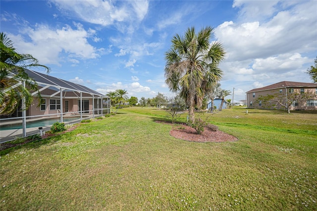 view of yard with a lanai and an outdoor pool