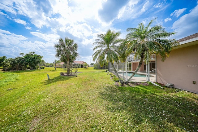 view of yard featuring a lanai and an outdoor pool