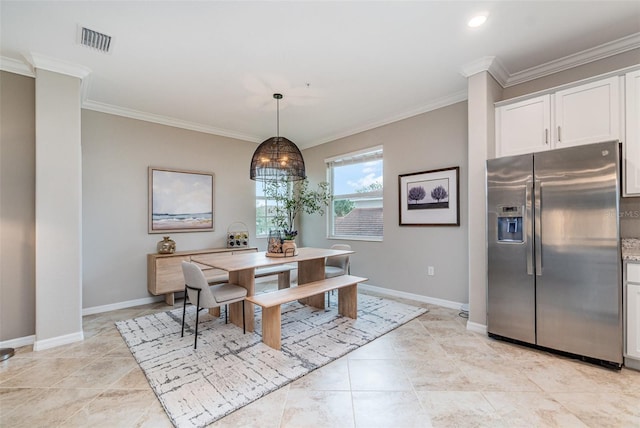 dining room with crown molding, baseboards, and visible vents