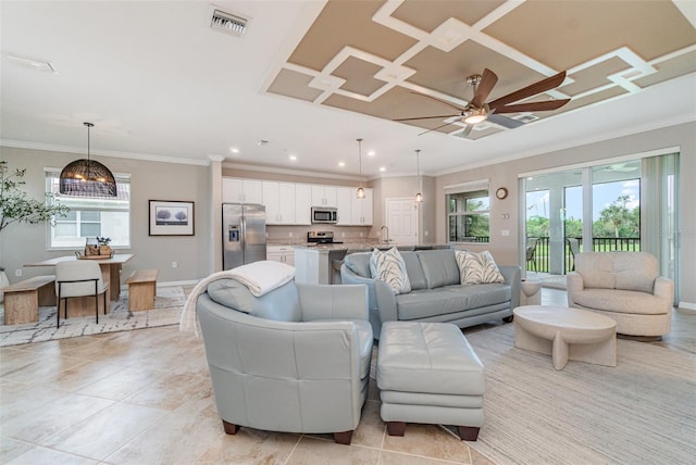 living room featuring visible vents, a healthy amount of sunlight, and ornamental molding