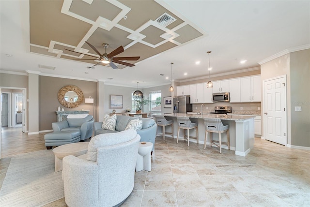 living area with visible vents, coffered ceiling, crown molding, and baseboards