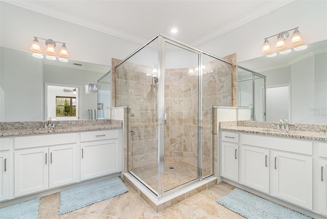 bathroom featuring a sink, a stall shower, and ornamental molding