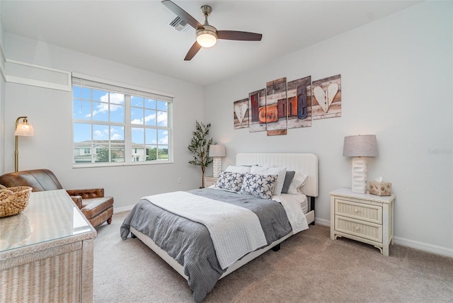 bedroom with carpet flooring, visible vents, a ceiling fan, and baseboards