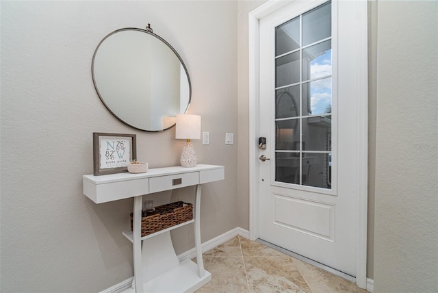 entryway with baseboards and light tile patterned flooring