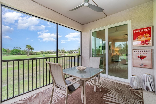 sunroom featuring a ceiling fan